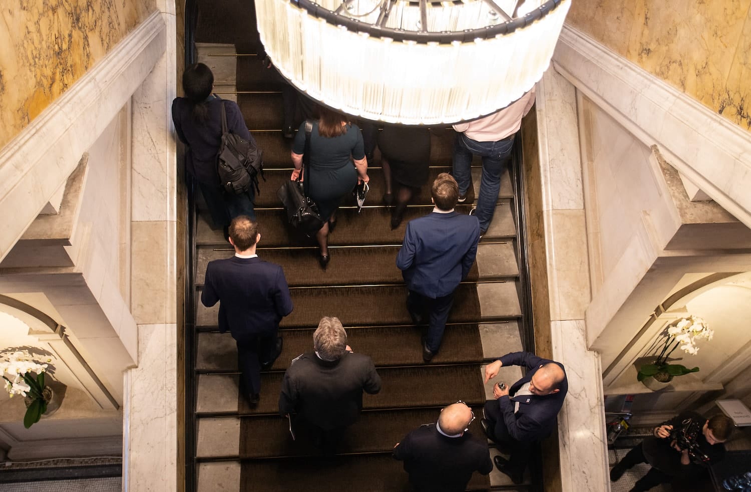 a group of people walking down a flight of stairs.